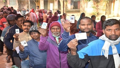 People stand in a queue to cast votes at a polling station during the final phase of Jharkhand Assembly Elections, in Ranchi district, Wednesday, Nov. 20, 2024. (PTI Photo)