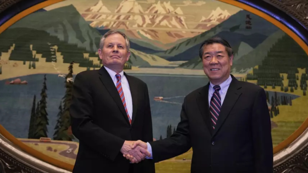 Chinese Vice Premier He Lifeng, right, shakes hands with U.S. Senator Steve Daines before a meeting held in the Xinjiang Room at the Great Hall of the People in Beijing, China, Saturday, March 22, 2025. (AP Photo/Ng Han Guan, Pool)