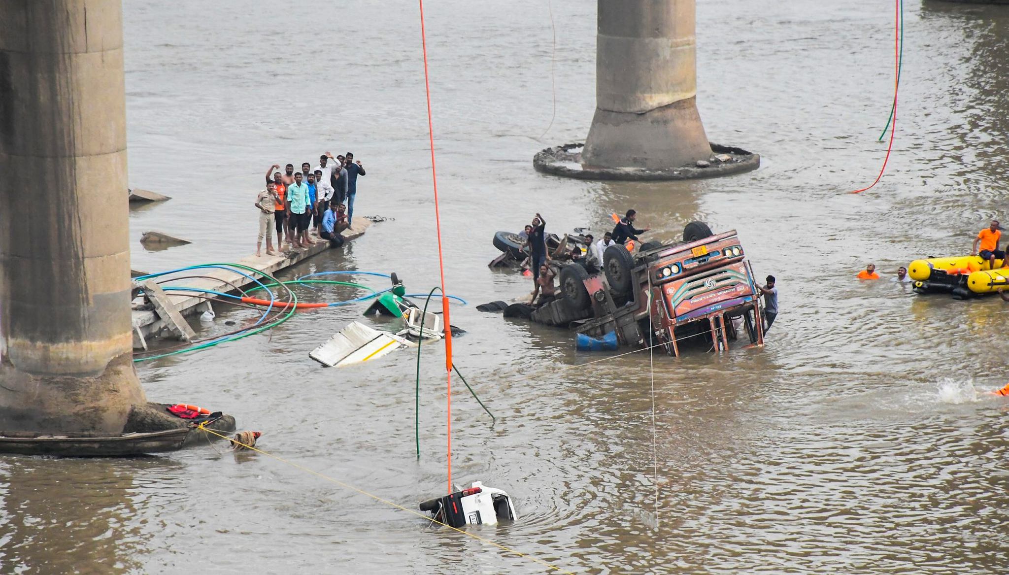 Rescue operation underway after several vehicles fell into the Mahisagar river when a portion of a four-decade-old bridge collapsed (Photo: PTI)