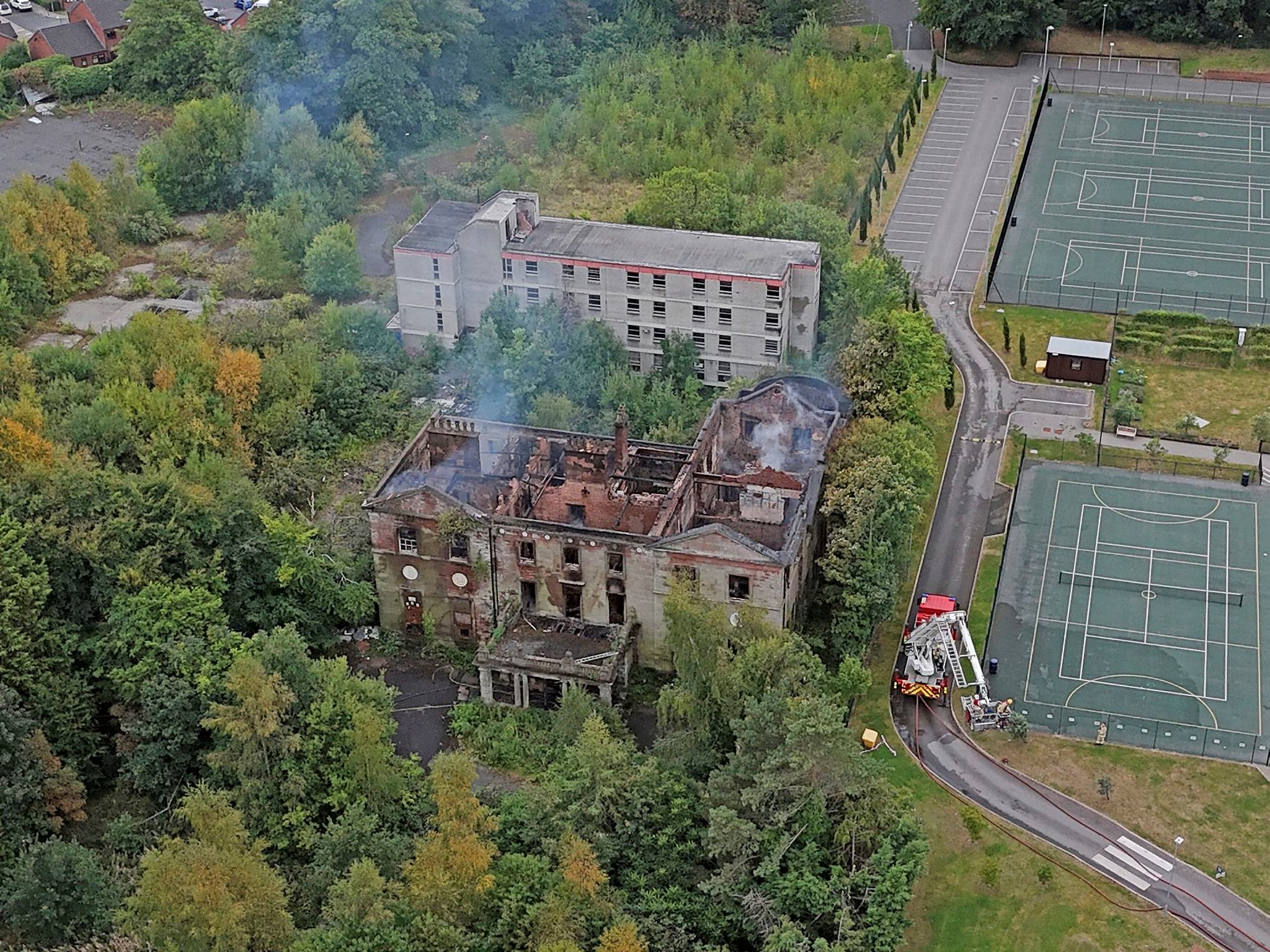 Fire crews work at the scene of Woolton Hall in Liverpool on Wednesday (Photo: AP)