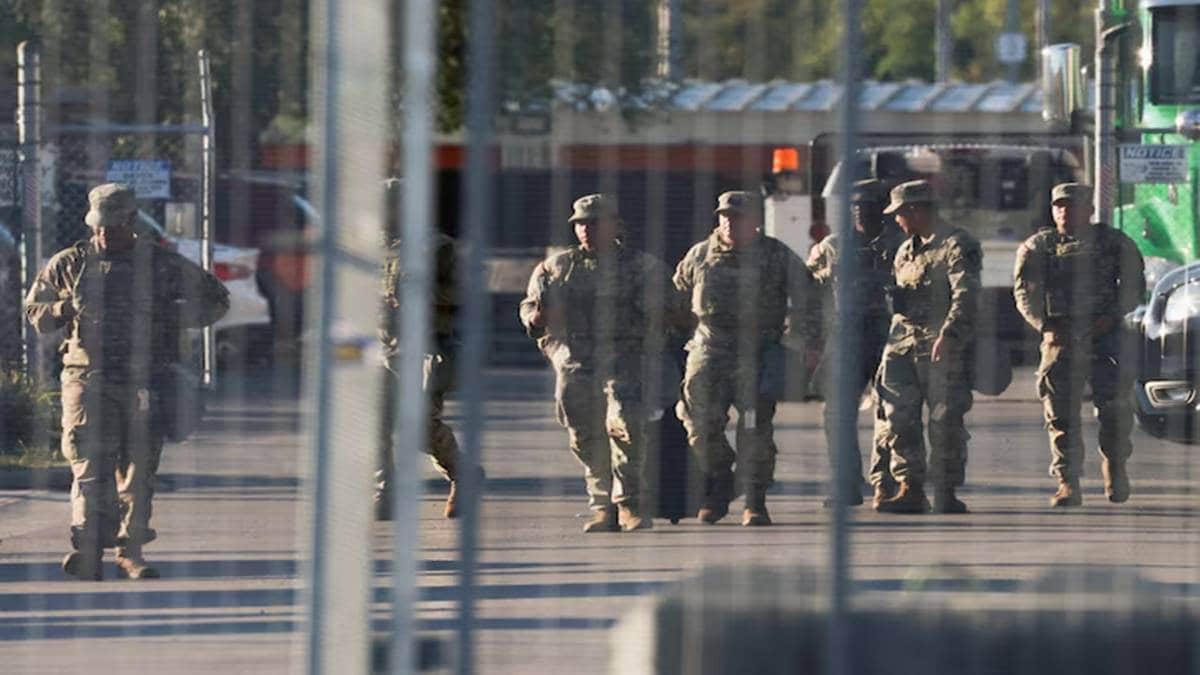 National Guard members walk at the U.S. Immigration and Customs Enforcement (ICE) Broadview facility in Chicago, Illinois, U.S., October 9, 2025. (Photo source: (Reuters)